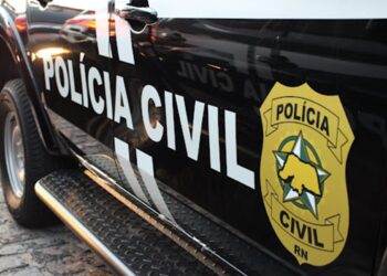 Lateral de viatura preta da Polícia Civil com brasão dourado e nome da corporação em destaque